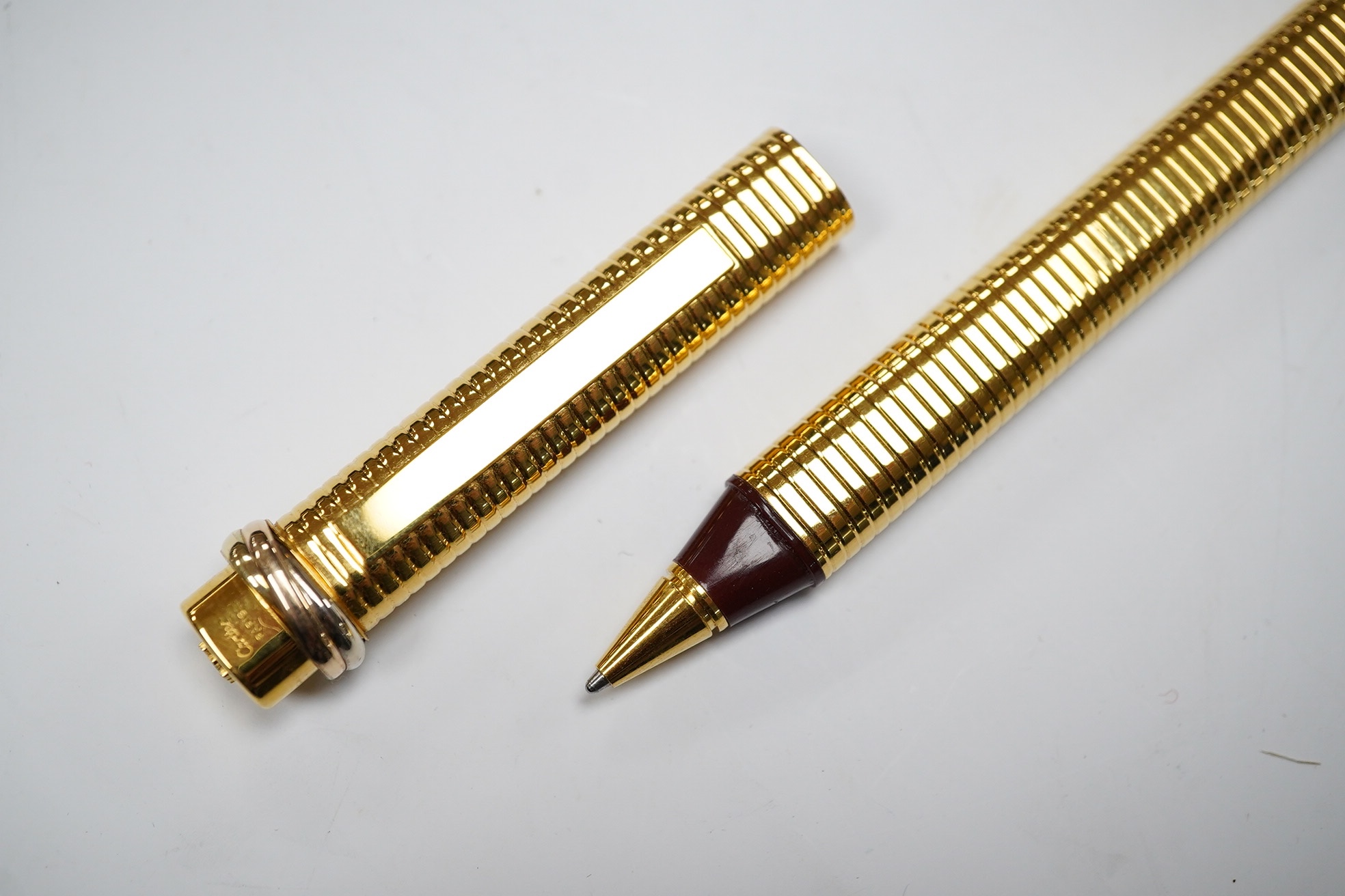 A Cartier gold plated pen and a Givenchy 18ct gold plated pen, both boxed. Cartier pen 13.5cm long. Condition - good, Givenchy box needs attention